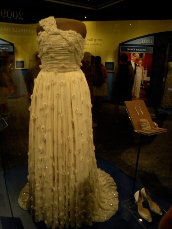 a very tall dress and some shoes on display