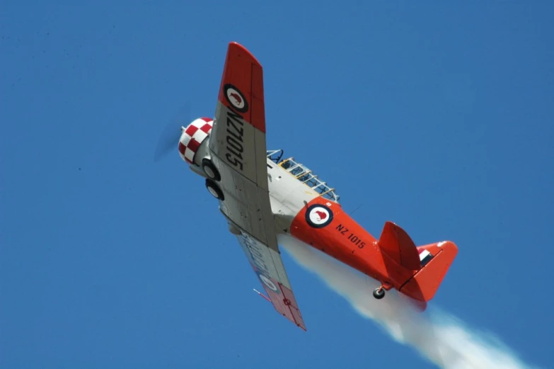 an old model plane is flying in the air