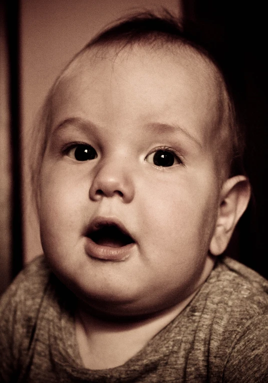 a close up of a child with an open mouth