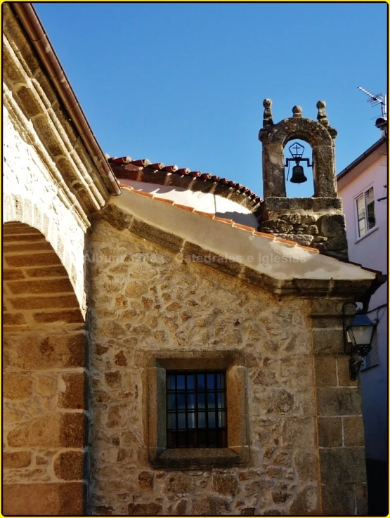 a bell on the outside wall of a building