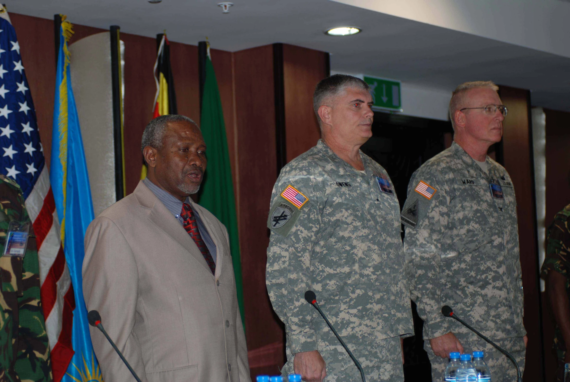 three military men are at a press conference