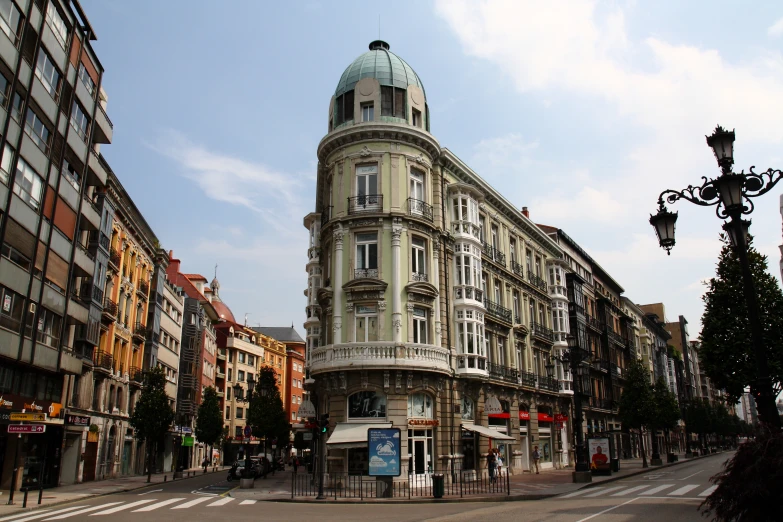 a view of a clock tower on the corner of a street