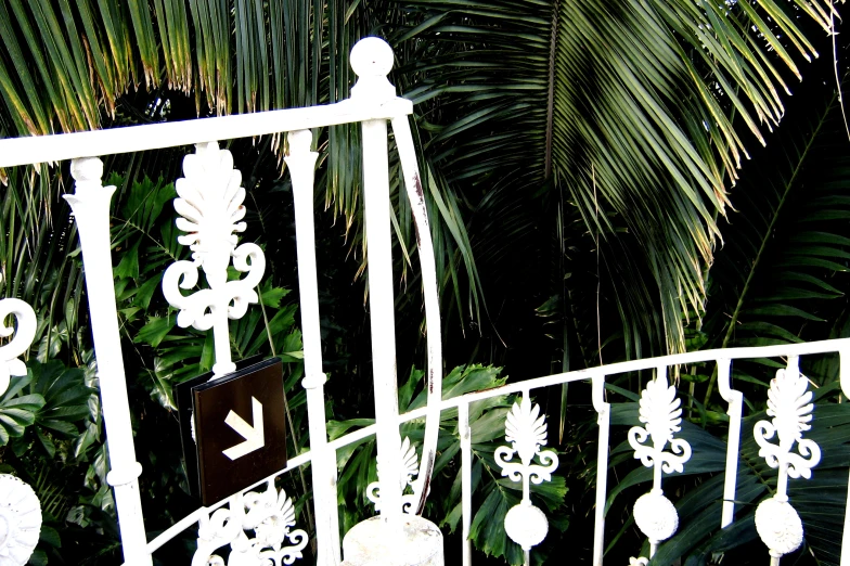 a wrought iron balcony railing that has a number of decorations