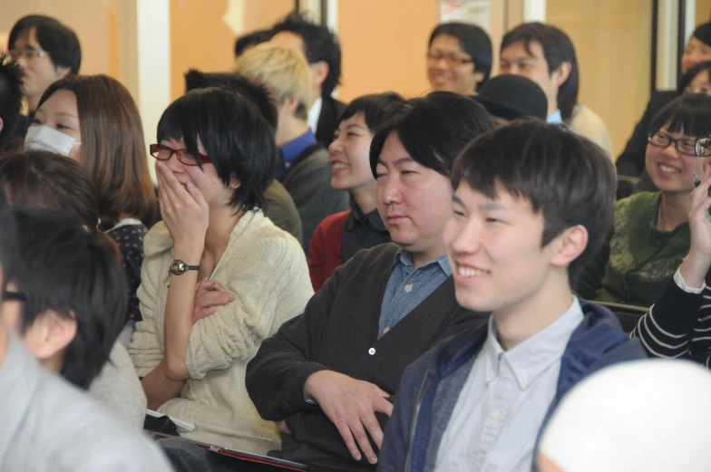 a crowd of people are sitting and talking