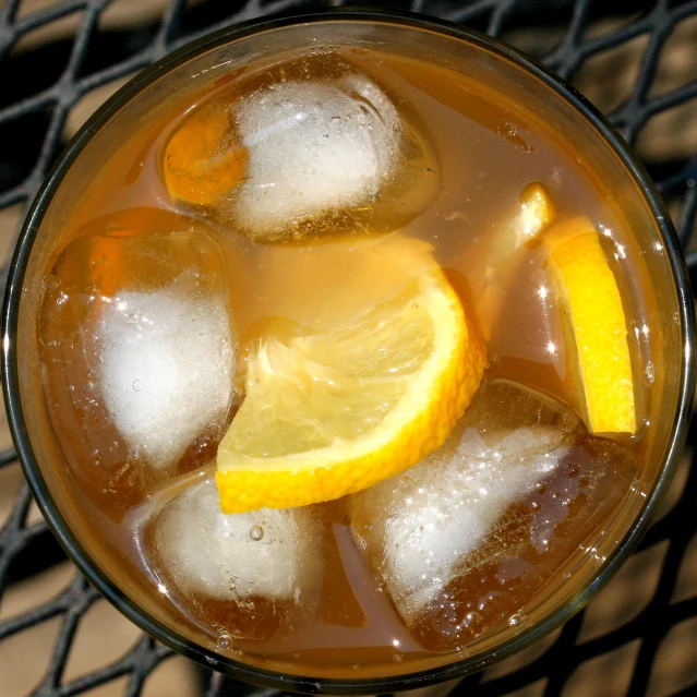 a glass filled with lemon tea with ice