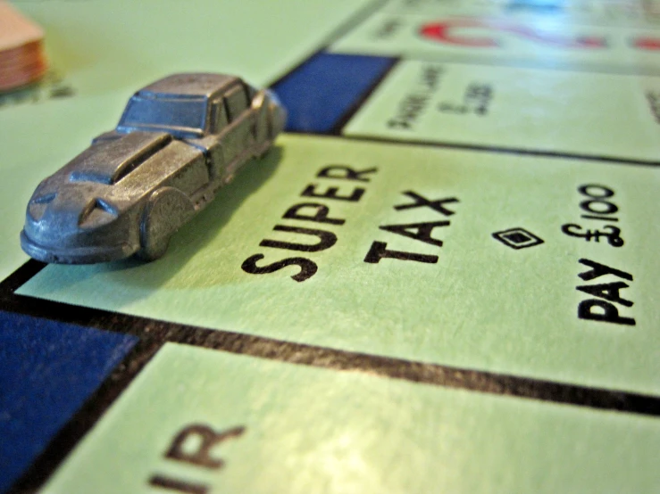 a toy car is on top of a monopoly board
