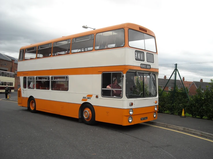 a large white and orange double decker bus