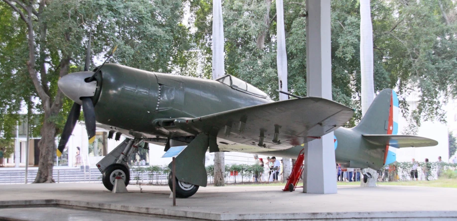 an old world war ii fighter plane on display