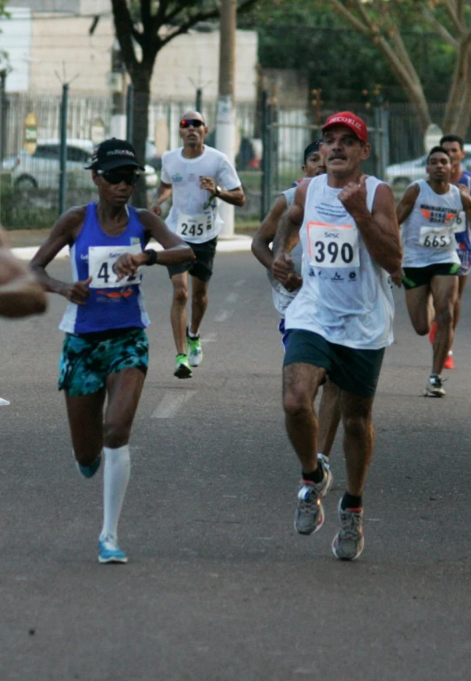 marathon runners are running down a busy road