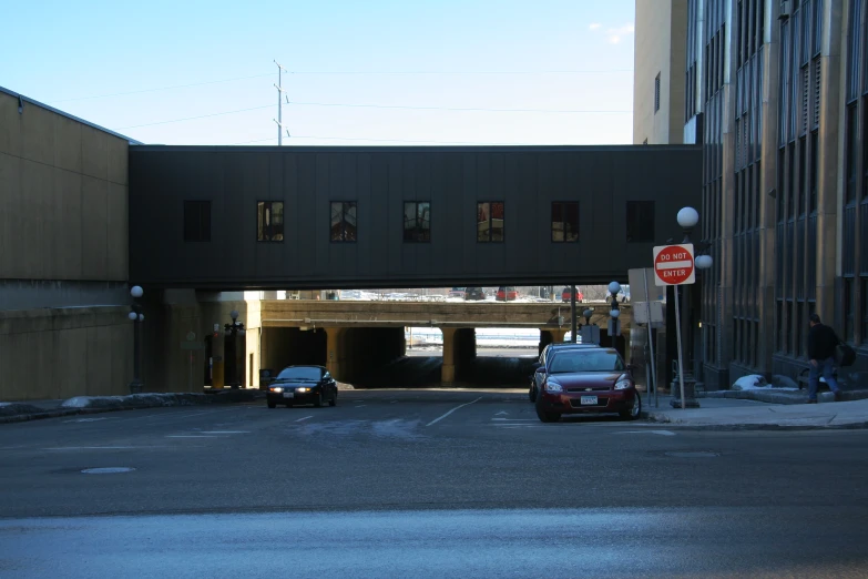 traffic driving under an overpass in an urban setting