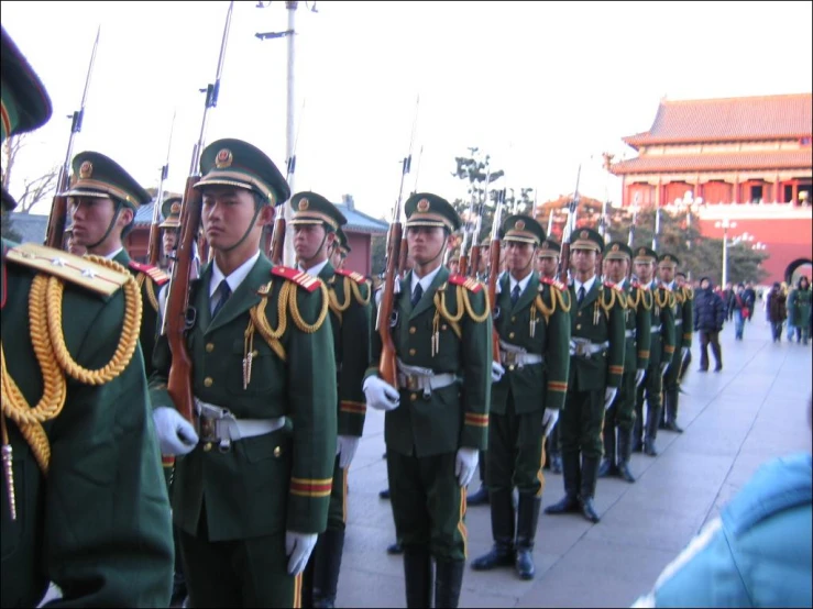 a military man is on the street holding his rifle