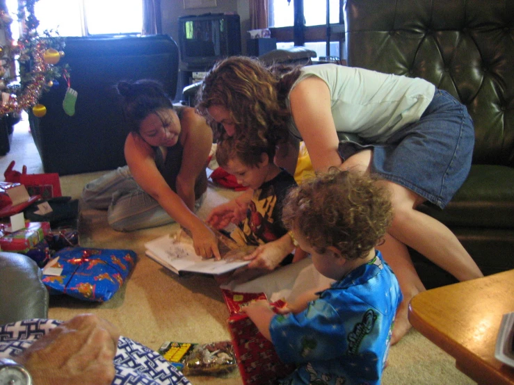 a woman helping a child do soing on the floor