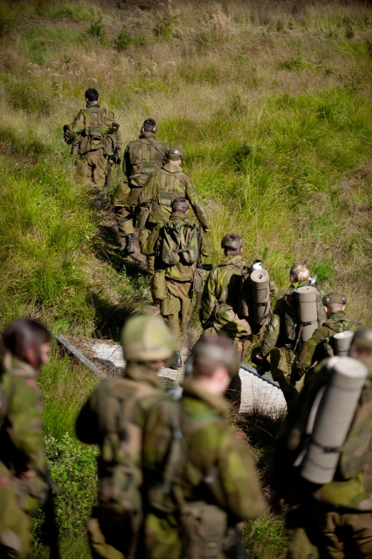 military personnel walking through a group of people