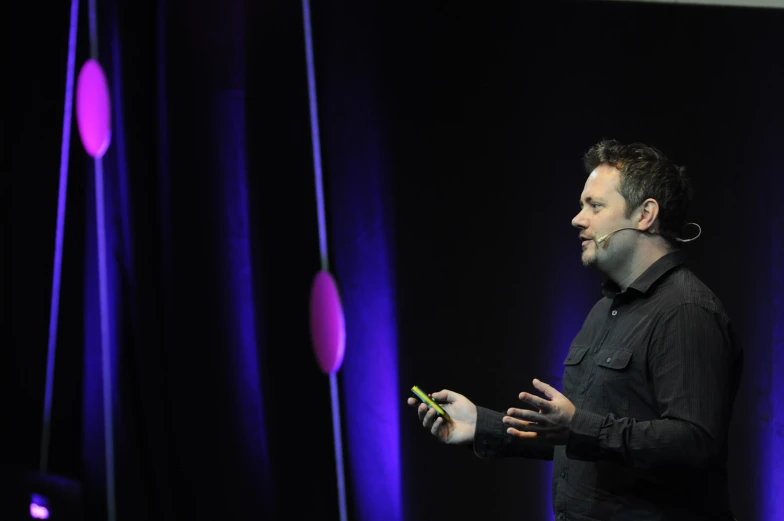 a man standing in front of purple lighting