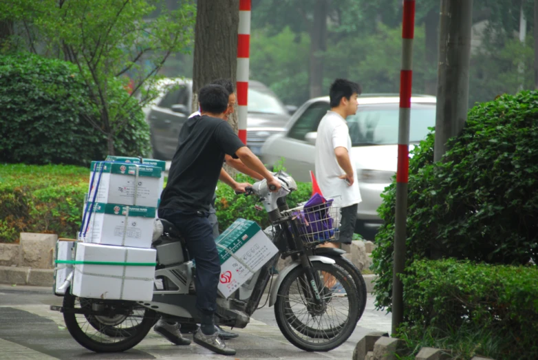 two men with carts on a motorbike on the street