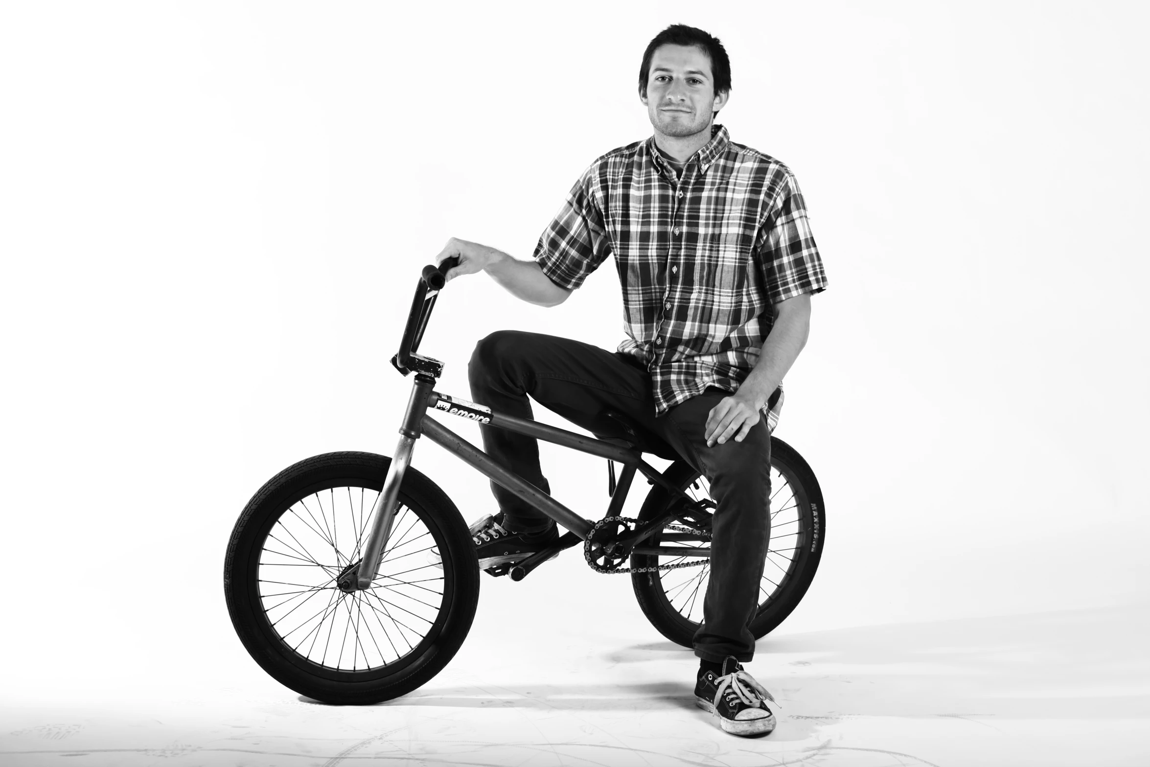 a man sitting on top of a bike on a white background