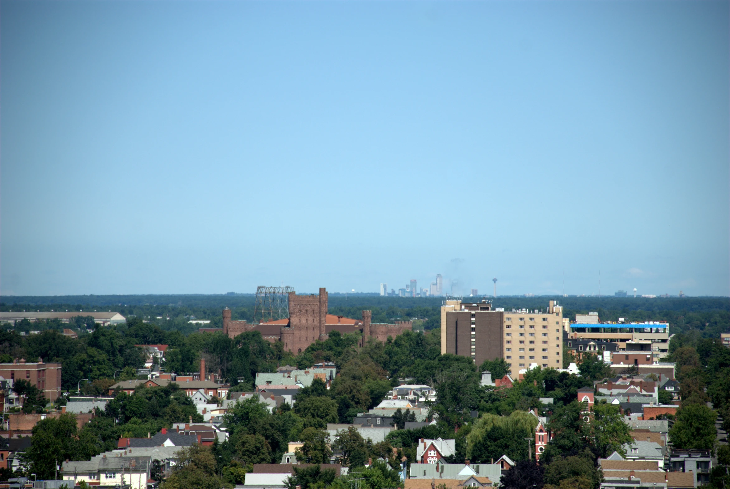 a view of the city, which sits below an oil refinery