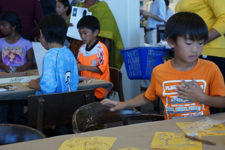 the children are enjoying their hands on paper