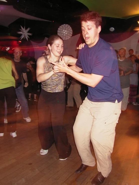 a couple dancing the salsa in a night club