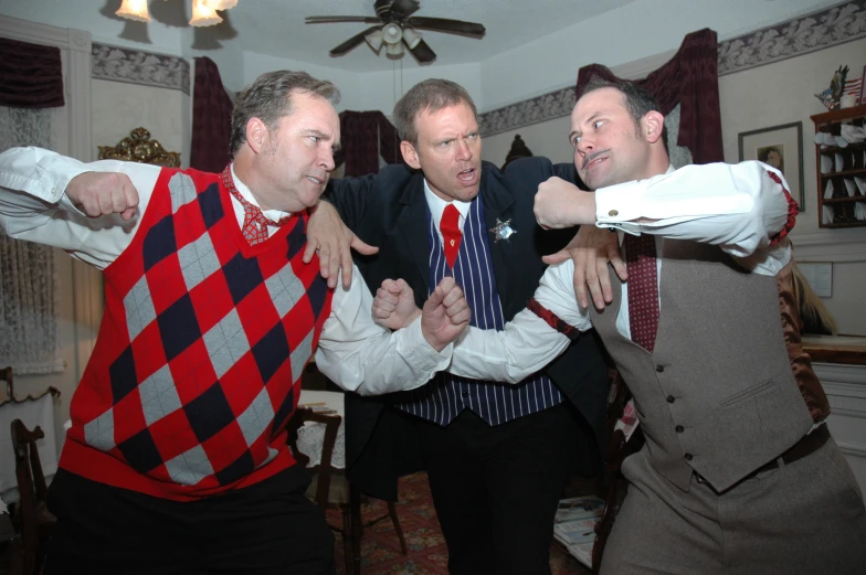 three men standing next to each other in a room