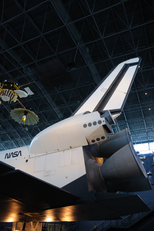 the space shuttle is being displayed in an indoor venue