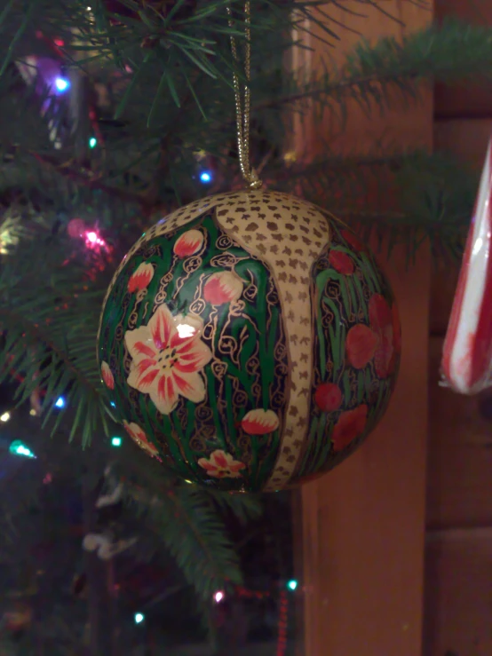 a christmas ornament hangs on a christmas tree