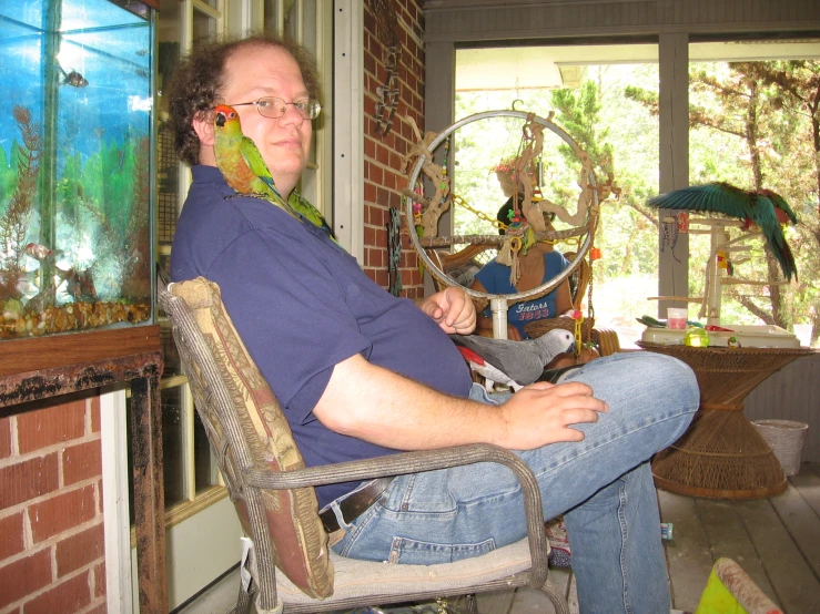 a man sits in a chair in a living room and looks at the camera