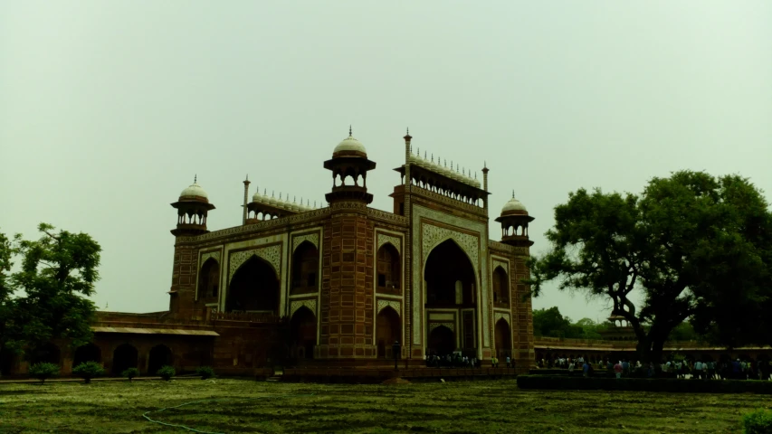 a large, ornate building sitting next to a tree