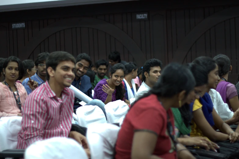 a group of people sitting in chairs next to each other