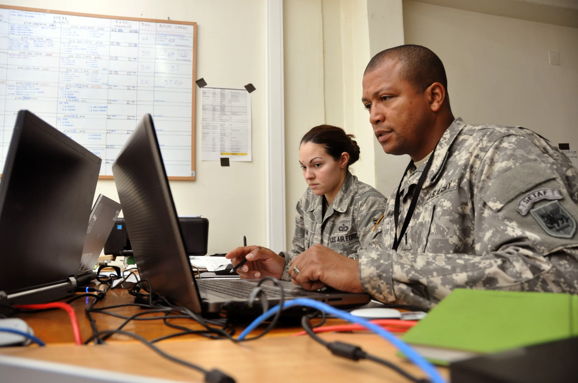 an air force commander in his office looking at her computer