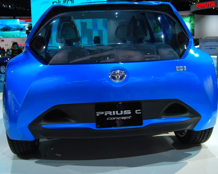 blue car with emblem and hatch open at display