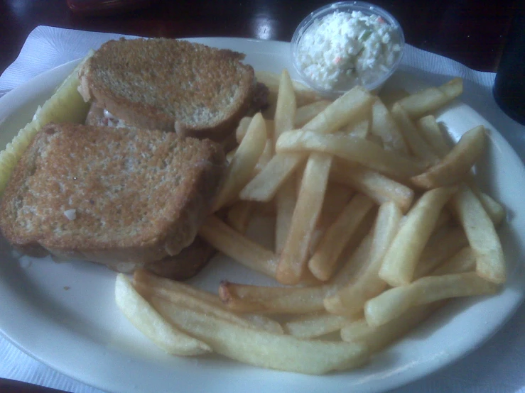 a sandwich and french fries sitting on a white plate