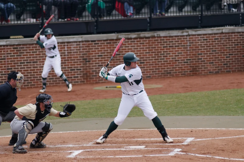 the baseball player is getting ready to swing at a pitch