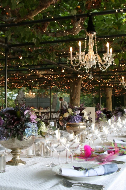 an outdoor dining room with tables set for dinner