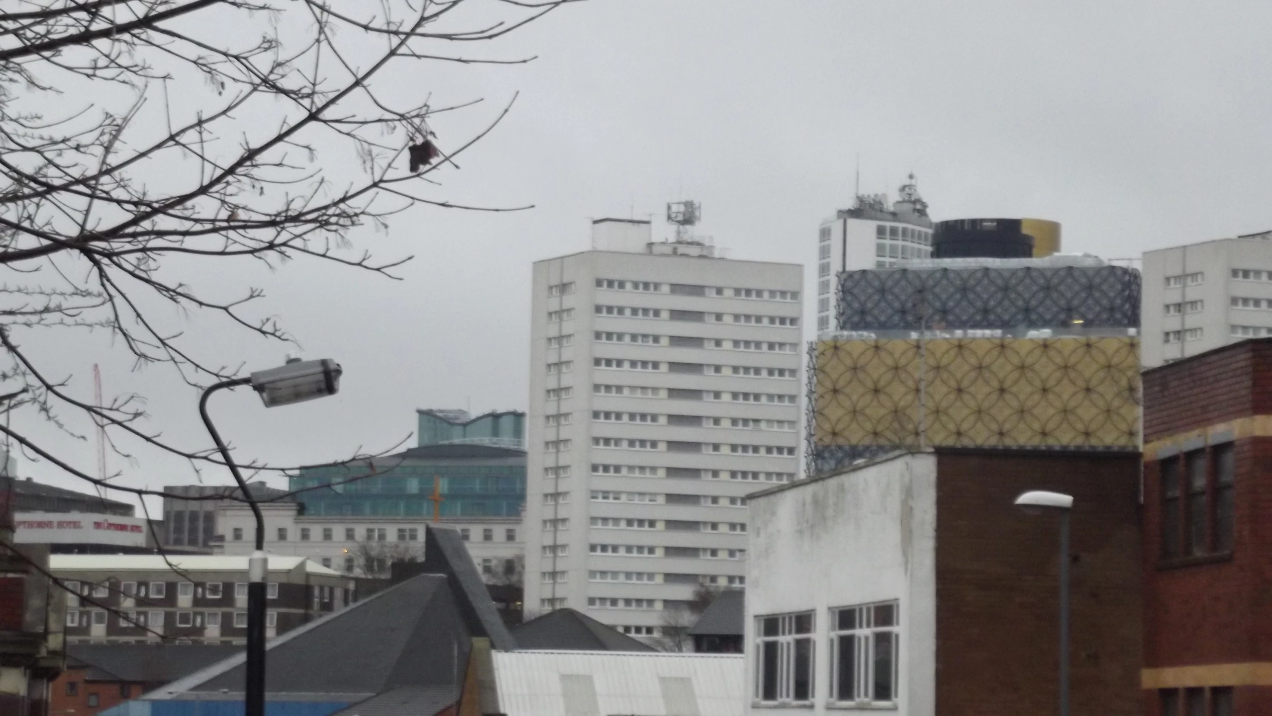 a view of some buildings from a distance on a very overcast day