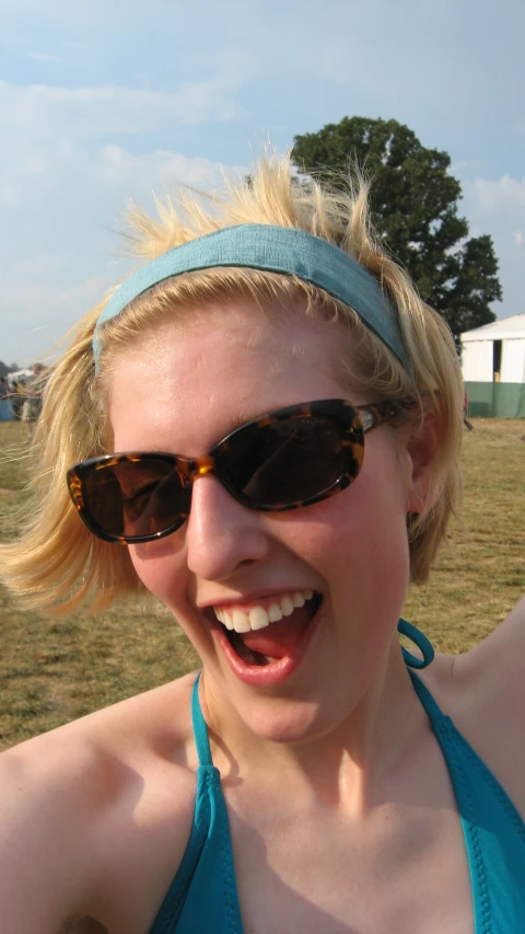 a blonde woman with sun glasses and a headband