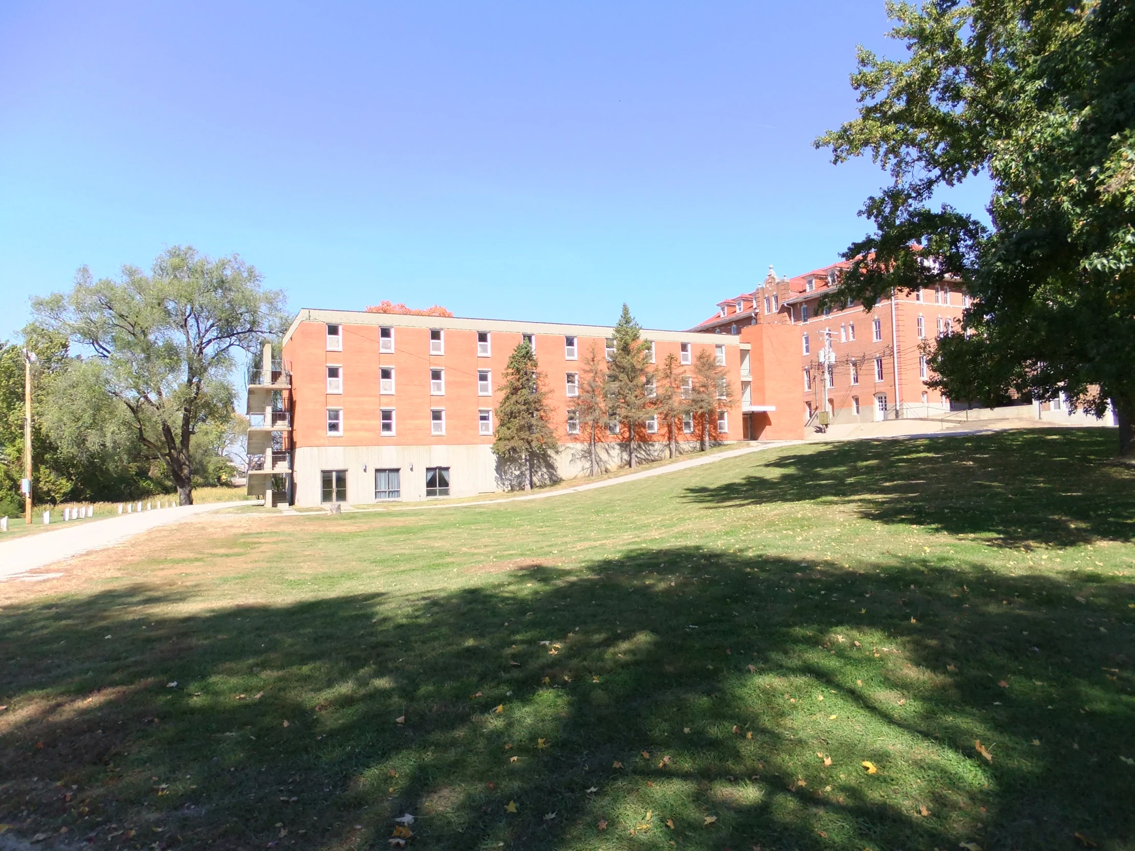 a green field with some buildings in the background