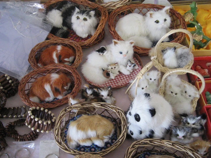 kittens, baskets and pine cones are arranged to be sold as wall decorations