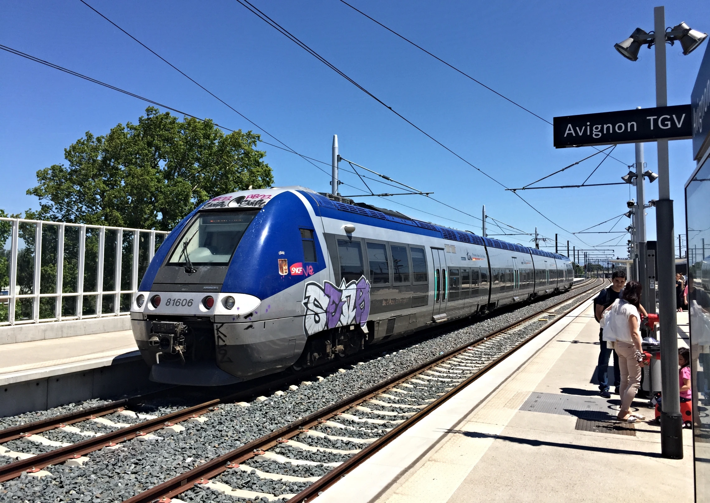 a train stopped on the railroad tracks in an empty station