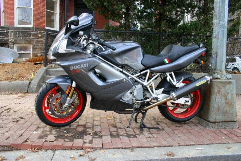 a parked motorcycle sitting next to a lamp post