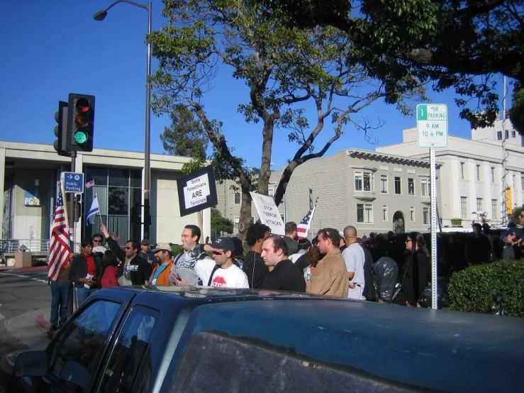 a group of people standing in the street with their hands together