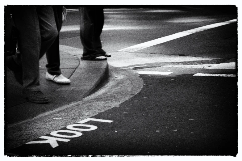 a person standing on a crosswalk next to an intersection