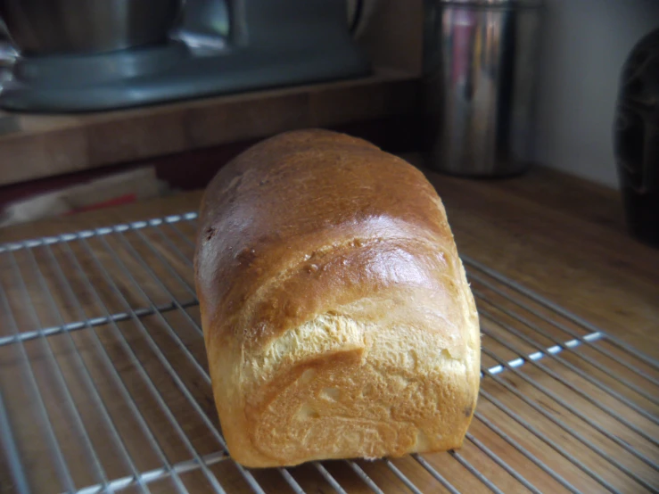 bread sitting on a baking rack with cooking utensils