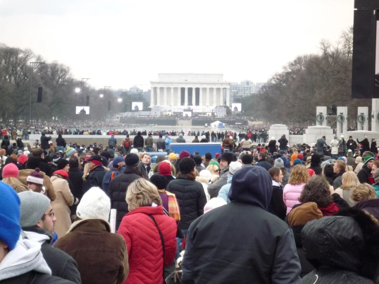 a crowd of people gathered around the lincoln memorial