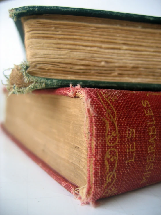 an old book with a green thread attached to the bindings