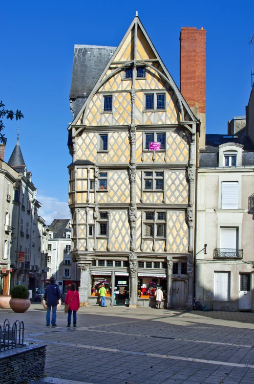 a group of people walking around a building