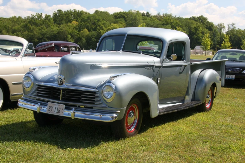 an old truck that is sitting in the grass