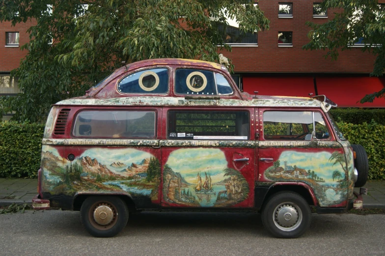 an old van painted with eyeballs and mountains