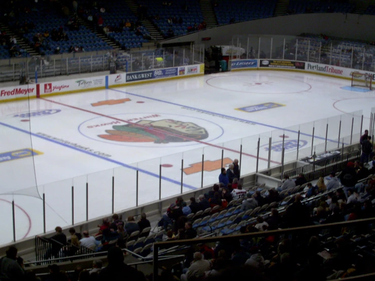 an empty ice rink filled with lots of people