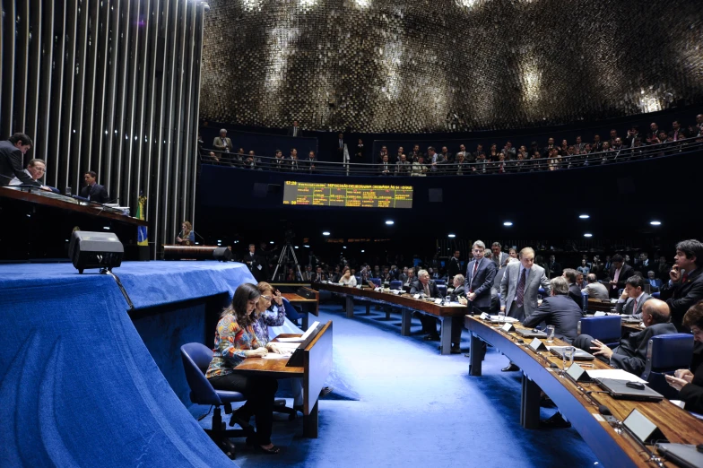 people are standing on the stage for an empty conference